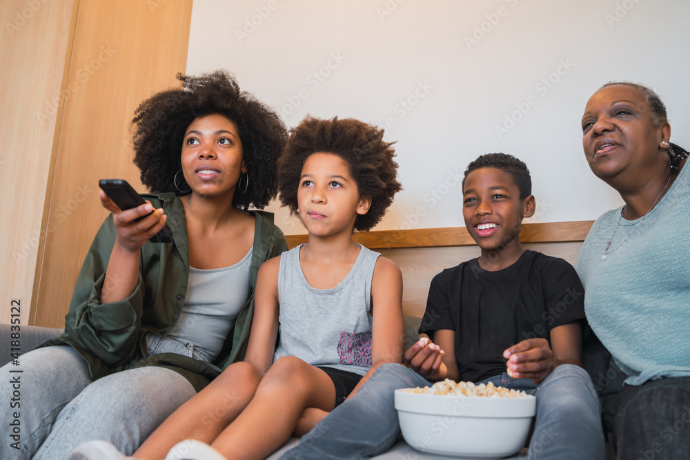 Grandmother, mother and children watching a movie at home. Grandmother, mother and children watching a movie at home.