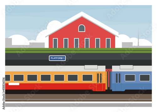 Passenger train stops at the railway station platform.