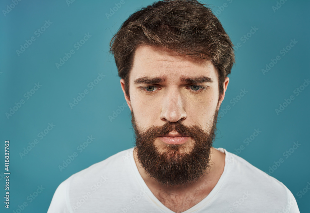 Fototapeta premium Sad man emotions white t-shirt cropped view close-up