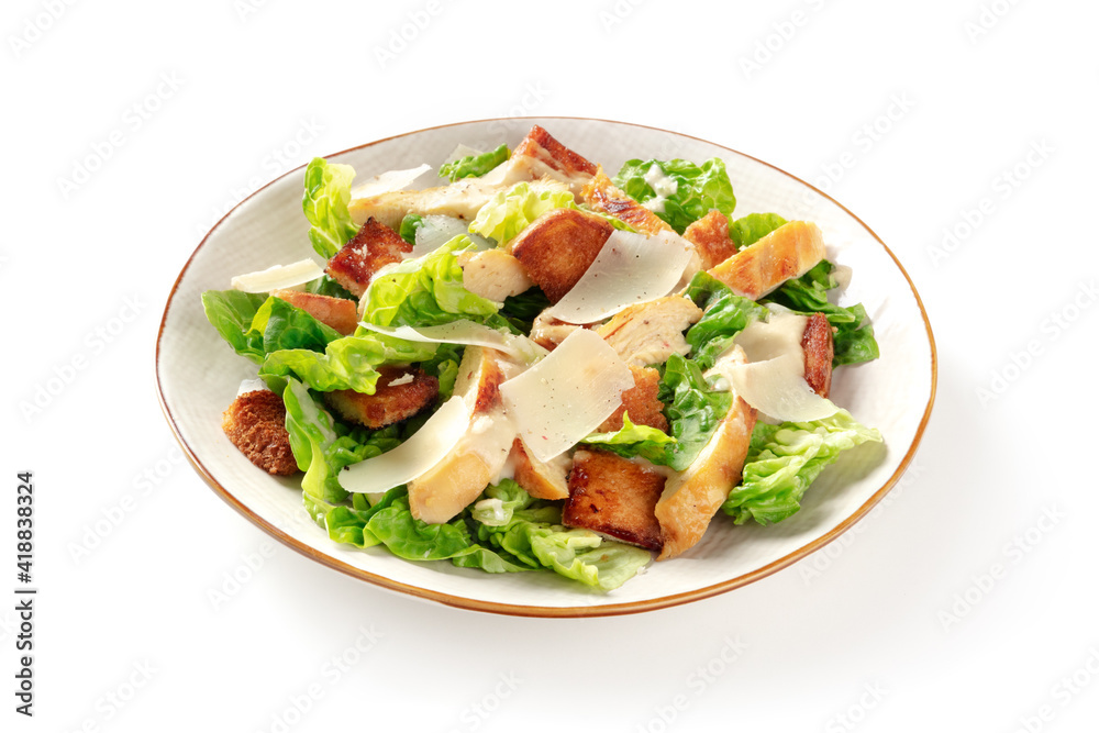 Caesar salad with grilled chicken meat, romaine leaves and Parmesan cheese on a white background Caesar salad with grilled chicken meat, romaine leaves and Parmesan cheese on a white background