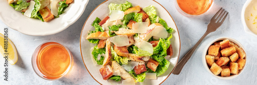 Caesar salad panorama with wine and croutons, the classic recipe with grilled chicken and Parmesan