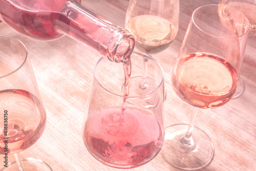 Rose wine pouring, toned image with many glasses Rose wine pouring, toned image with many glasses