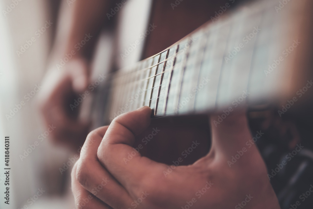 Fototapeta premium close up of a person playing guitar