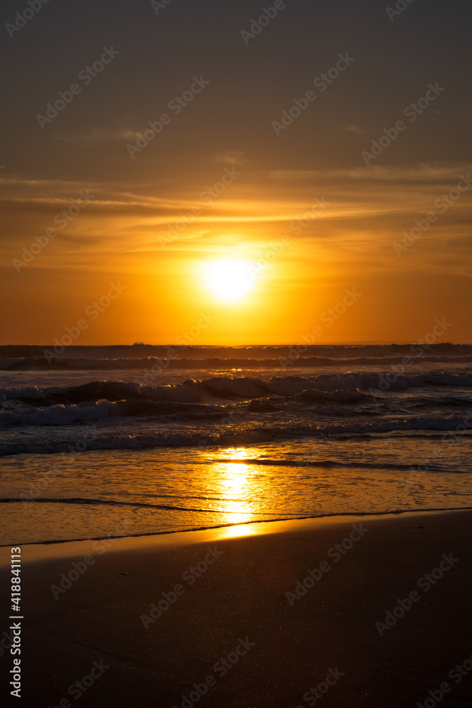 Obraz premium Sunset and beach. Seascape background. Bright sunlight. Sun at horizon line. Scenic view. Sunset golden hour. Sunlight reflection in water. Magnificent scenery. Copy space. Bali