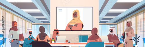 team of arabic medical specialists having video conference with female black muslim doctor medicine healthcare concept hospital meeting room interior horizontal portrait vector illustration