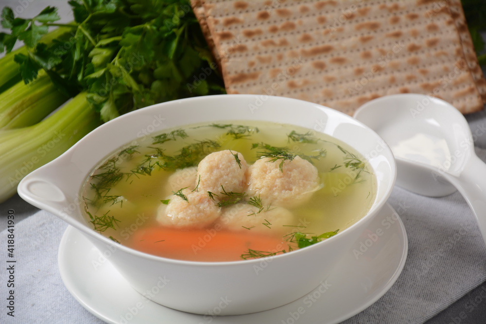 Chicken Matzo ball soup with carrots in the bowl. Jewish traditional Passover holiday food Chicken Matzo ball soup with carrots in the bowl. Jewish traditional Passover holiday food