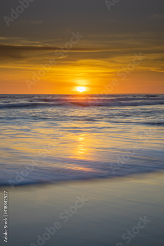 Sunset and beach. Seascape background. Bright sunlight. Sun at horizon line. Scenic view. Sunset golden hour. Sunlight reflection in water. Magnificent scenery. Copy space. Bali