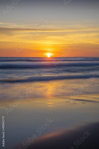Sunset and beach. Seascape background. Bright sunlight. Sun at horizon line. Scenic view. Sunset golden hour. Sunlight reflection in water. Magnificent scenery. Copy space. Bali © Olga