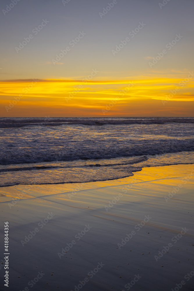 Yellow sunset on the beach. Seascape for background. Colorful sky. Beautiful water reflection. Sunlight on horizon line. Nature and environment concept. Copy space. Sunset in Bali. Yellow sunset on the beach. Seascape for background. Colorful sky. Beautiful water reflection. Sunlight on horizon line. Nature and environment concept. Copy space. Sunset in Bali.