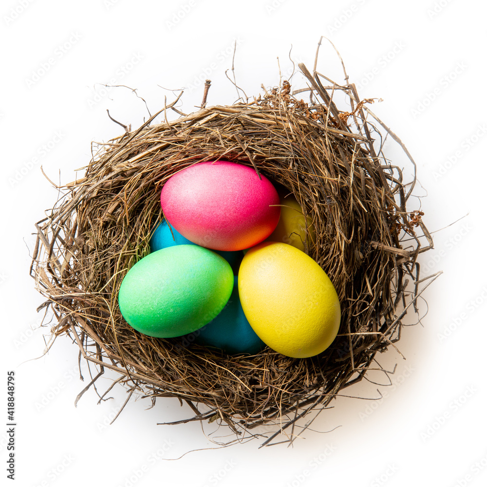 Nest with easter colorful eggs isolated on white. Dyed multi-colored eggs. Happy Easter concept. Top view. Nest with easter colorful eggs isolated on white. Dyed multi-colored eggs. Happy Easter concept. Top view.