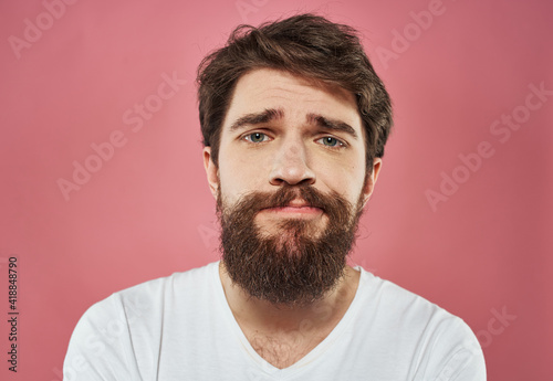 Male cropped view portrait of brunet bushy beard white t-shirt