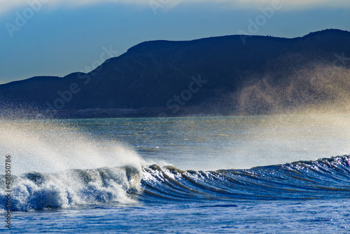 Fototapeta Naklejka Na Ścianę i Meble -  Sea waves forming white foam on sunny day.