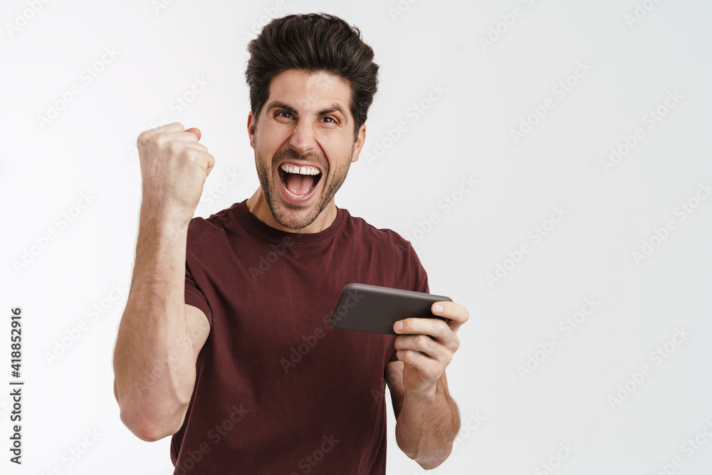 Tense handsome man playing online game on cellphone Tense handsome man playing online game on cellphone