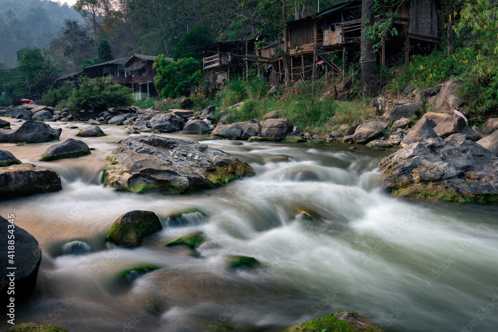 The dry river has many boulders and green moss grows on the rocks in summer. The dry river has many boulders and green moss grows on the rocks in summer.