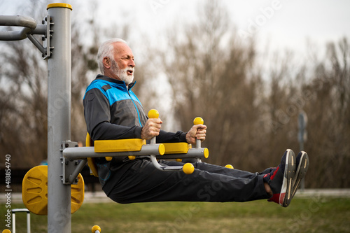 Konstfotografi Active senior man is exercising on outdoor gym