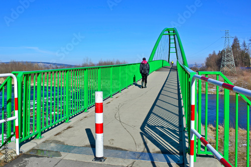 Walking and cycling path across the Poprad river over a bridge in green color, Stary Sacz, Poland © Jurek Adamski