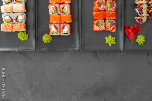 Set of sushi rolls served on gray background