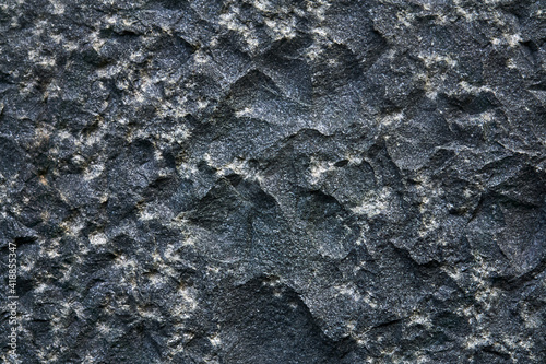 background, texture - the surface of a roughly hewn granite block