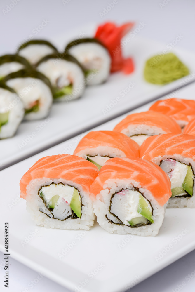 Maki Sushi - Roll made of smoked salmon and cream cheese. Traditional Japanese cuisine concept, over white background.