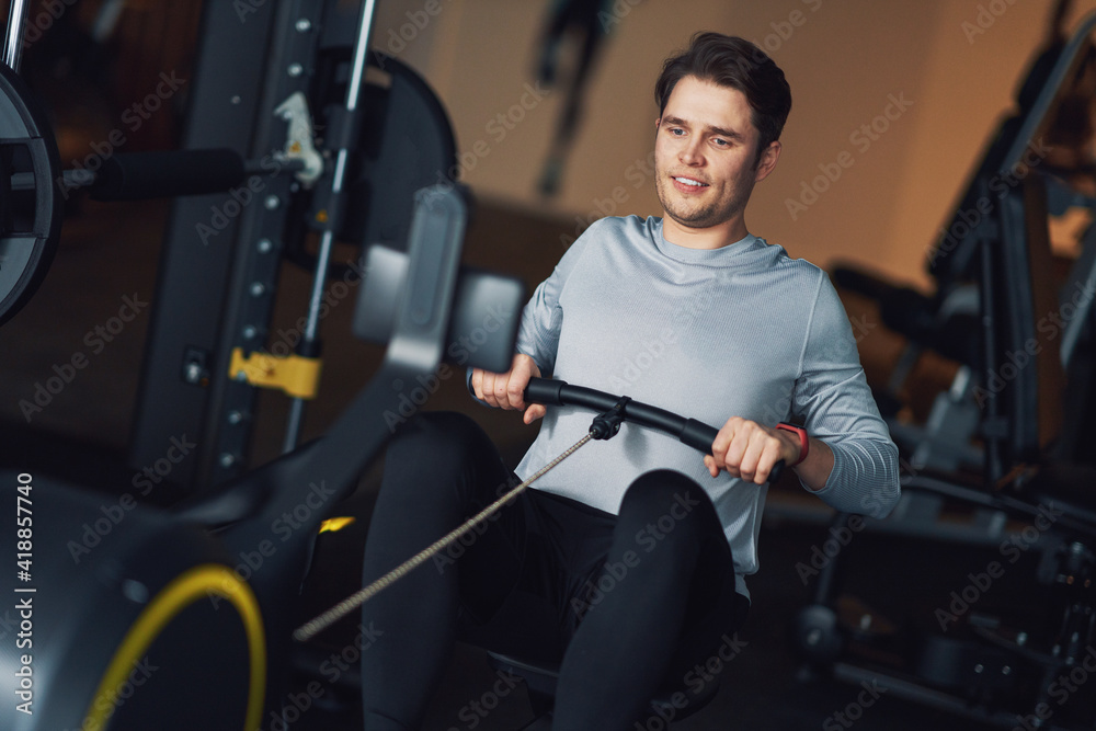Adult man working out in a gym Adult man working out in a gym