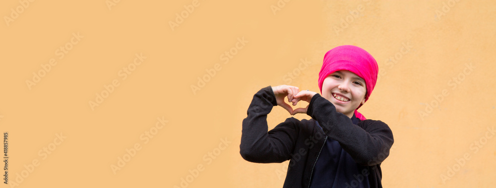 portrait of smiling girl with headscarf and making heart symbol with hands portrait of smiling girl with headscarf and making heart symbol with hands