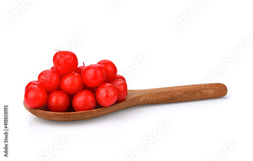 Maraschino cherries red on a wooden spoon on a white background.