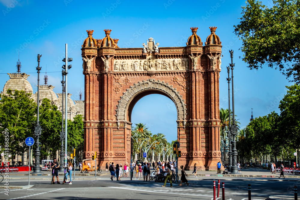 Barcelona, Spain - July 25, 2019: Tourists and locals walking through the Triumphal Arch of Barcelona in Spain