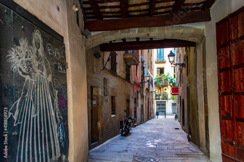 Barcelona, Spain - July 25, 2019: Narrow street with no people in the Roman quarter of Barcelona in Spain