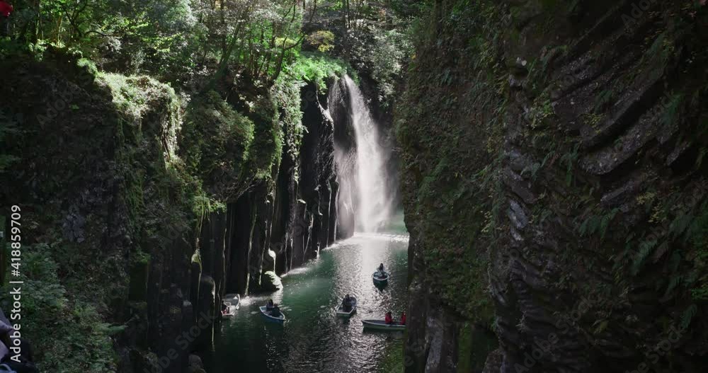 Waterfall in the mountains at Takachiho gorge, Miyazaki, Japan. Rowing a boat in a volcanic canyon near one of the most beautiful waterfall in Japan. Waterfall in the mountains at Takachiho gorge, Miyazaki, Japan. Rowing a boat in a volcanic canyon near one of the most beautiful waterfall in Japan.