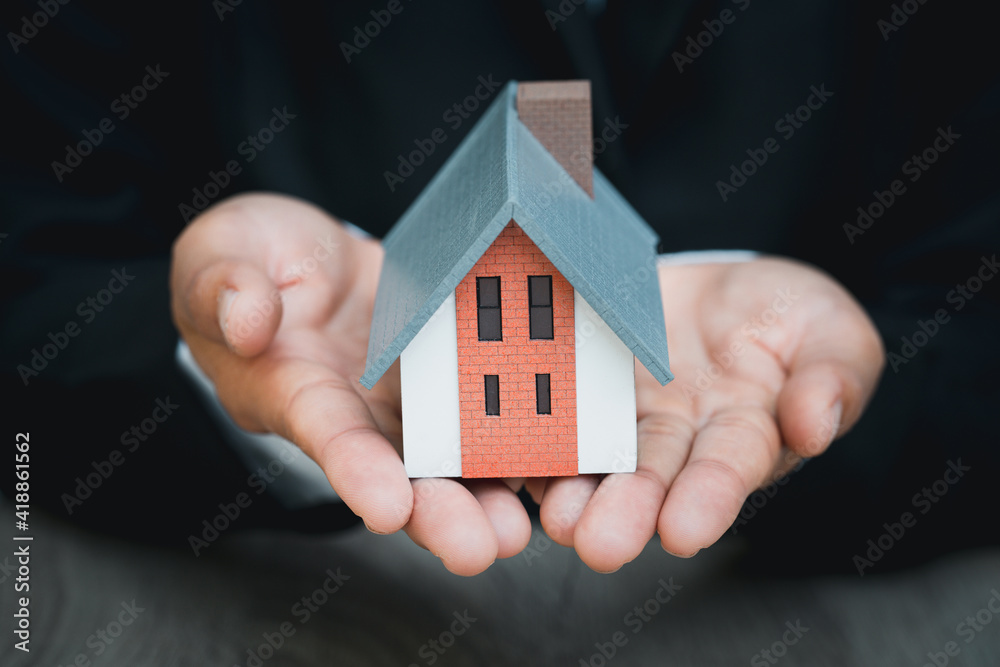 Real estate agent offer house represented by model. Real estate agent offer house represented by model.