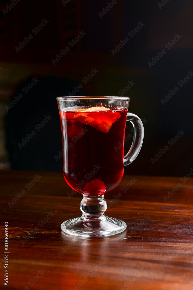 Closeup of mulled wine, in a glass over Traditional Ukrainian tablecloth. Christmas time, winter time. Closeup of mulled wine, in a glass over Traditional Ukrainian tablecloth. Christmas time, winter time.