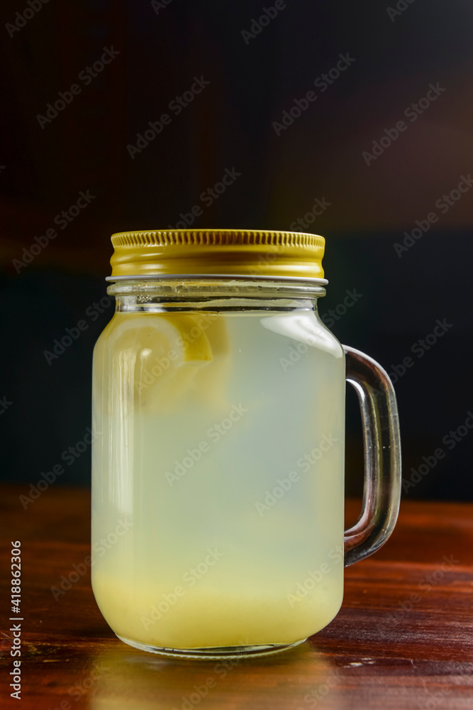 Ginger tea with lemon and mint over black background. Ukrainian cuisine concept, Christmas time.