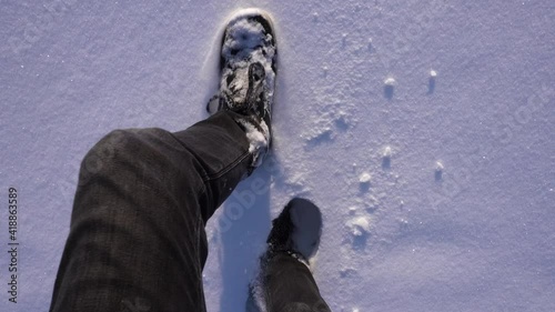 Legs walking through deep snow.