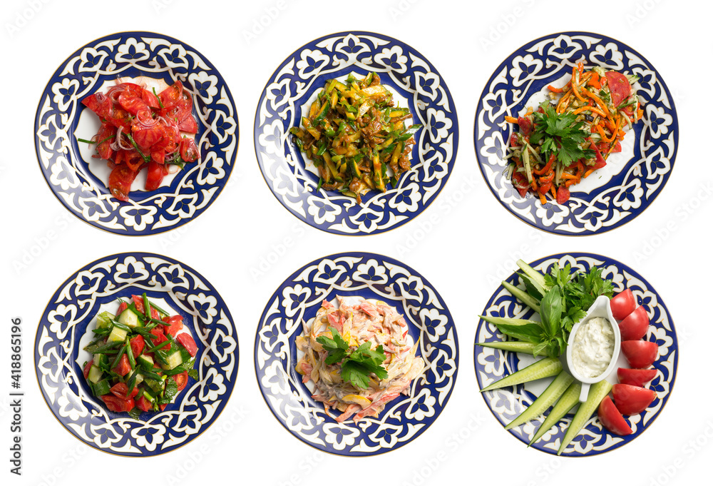 A set of salads and cold appetizers in plates with a traditional Uzbek pattern. A set of salads and cold appetizers in plates with a traditional Uzbek pattern.