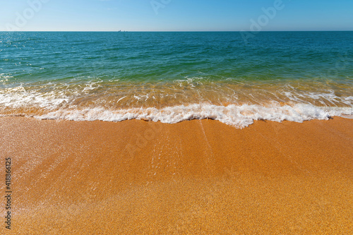 Fototapeta Naklejka Na Ścianę i Meble -  Soft sea wave on a sandy beach without people on a sunny day