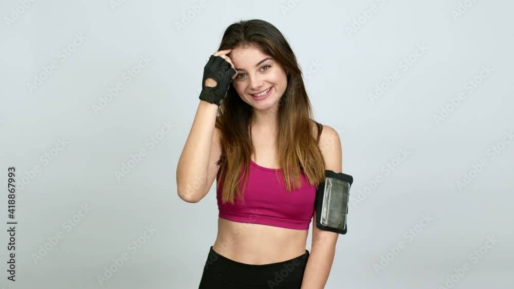 Young caucasian woman with sports clothes with happy face over isolated background Young caucasian woman with sports clothes with happy face over isolated background