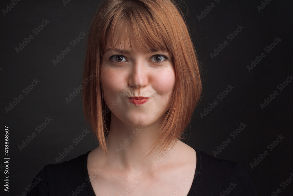 studio portrait of a young brown-haired woman, on a black background studio portrait of a young brown-haired woman, on a black background