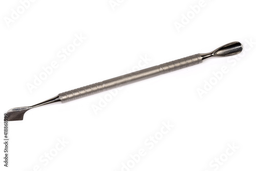 Stainless steel cuticle pusher on a white background