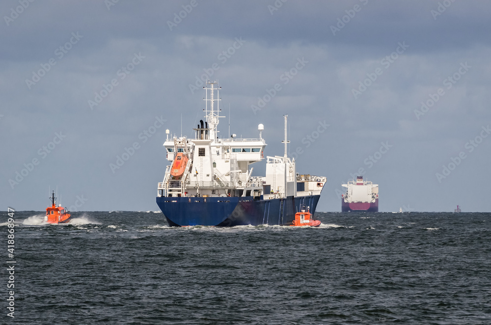 MERCHANT VESSEL  - The freighter follows waterway