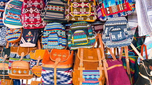 Traditional colorful Ecuadorian bags on displayof the marketplace in Otavalo