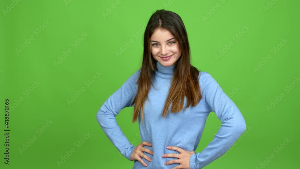 Young caucasian woman posing with arms at hip and laughing over isolated background. Green screen chroma key Young caucasian woman posing with arms at hip and laughing over isolated background. Green screen chroma key
