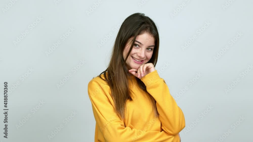 Young caucasian woman smiling and looking to the front with confident face over isolated background Young caucasian woman smiling and looking to the front with confident face over isolated background