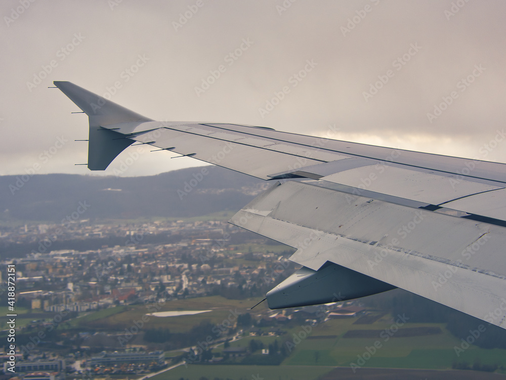 Wing of passenger aircraft, approaching Zurich airport, Switzerland. Focus on wing