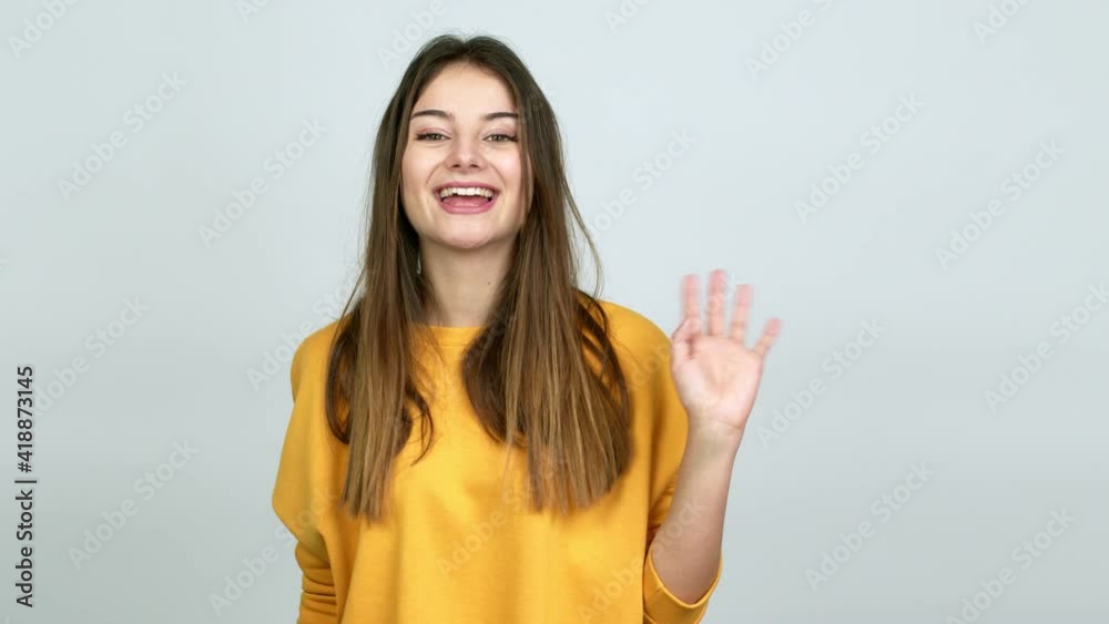 Young caucasian woman saluting with hand with happy expression over isolated background Young caucasian woman saluting with hand with happy expression over isolated background