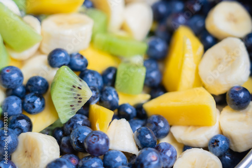Fruit salad with fresh blueberries, bananas, kiwi and mango