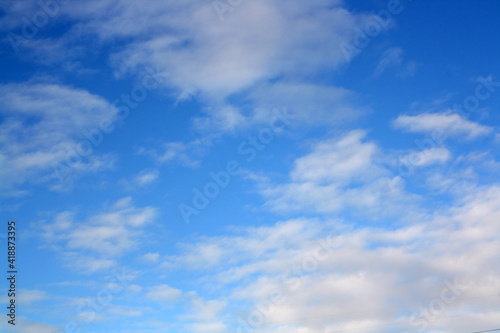 Blue sky with floating white clouds.
