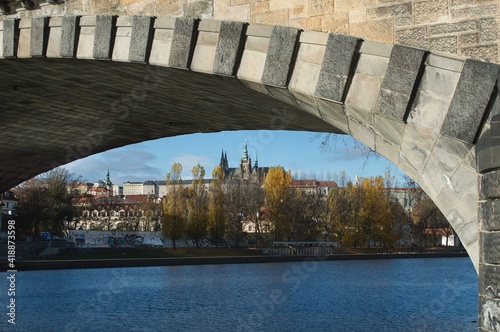 View of Prague Castle from the river bank under the arch of the bridge © Magdalena
