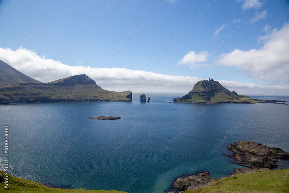 Faroe islands. beautiful landscape - blue sky, sea and mountains in the Faroe Islands.