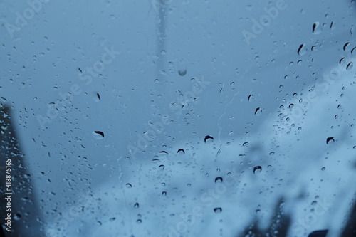 raindrops on the window with snow and snow-capped mountains in the background