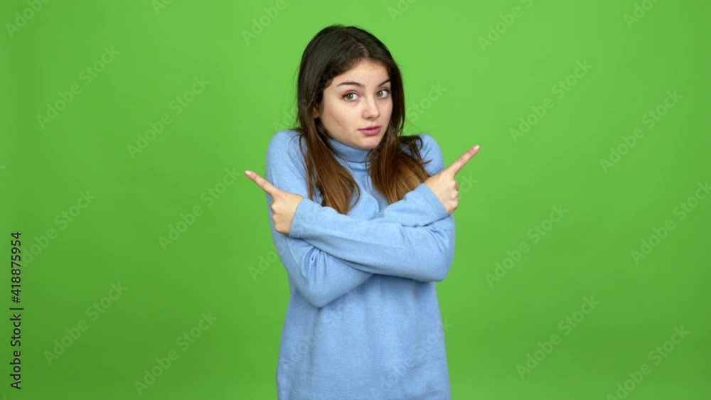 Young caucasian woman pointing to the laterals having doubts over isolated background. Green screen chroma key Young caucasian woman pointing to the laterals having doubts over isolated background. Green screen chroma key